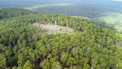 Aerial-footage-over-fire-tower-and-native-forest-on-Blue-Mountain,-near-Newbury-in-central-Victoria,-Australia