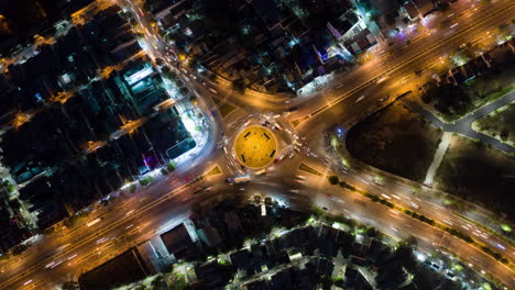 Hyperlapse-Timelapse-of-Night-City-Traffic-on-4-way-Roundabout-Intersection-in-Vietnam---Aerial