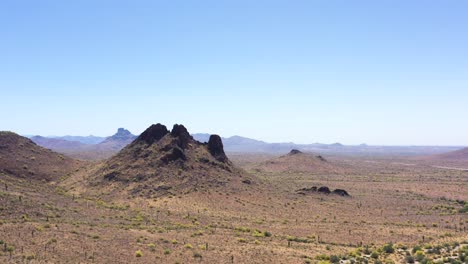 Aerial,-slow-approach-to-an-icon-volcanic-butte-found-on-the-McDowell-Mountains,-Salt-River-Indian-Reservation,-Scottsdale,-Arizona