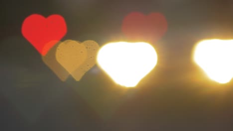 Beautiful-hearts-bokeh-from-moving-car-and-traffic-lights-at-the-evening,-Valentines-Day-or-social-media-Like-background-concept