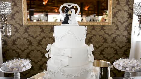 Truck-detailed-capture-of-a-delicious-wedding-cake,-with-cute-handmade-bride-and-groom-cake-topper-on-a-decorated-sweetiesâ€™-table