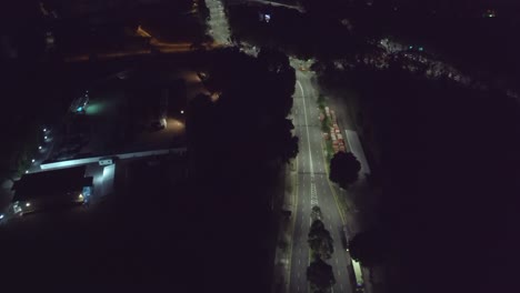 Aerial-rising-drone-shot-of-Singapore-skyline-at-night