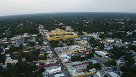 Aerial-flying-over-Izamal,-Mexico-during-early-evening