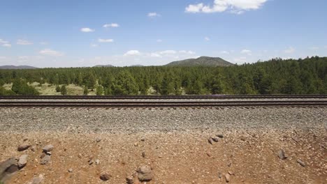 Aerial-pan-along-the-railroad-tracks-near-Williams-Arizona