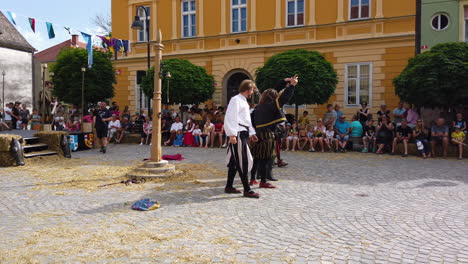 Slow-motion-of-warriors-bowing-to-the-crowd-after-Medieval-reenactment-of-sword-fighting,-Preludij-festival-in-Slovenj-Gradec-slovenia