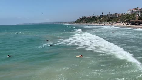 People-leisurely-surfing-and-enjoying-the-summer-sun-at-San-Clemente-Beach-in-Southern-California