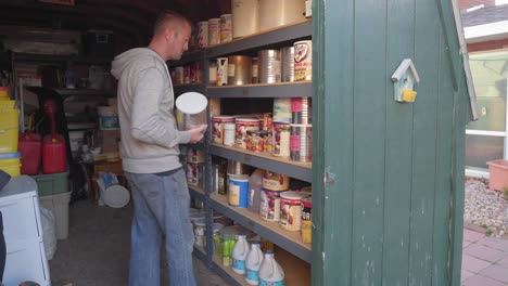 Man-walks-into-backyard-shed-to-retrieve-a-few-cans-of-goods-from-food-storage