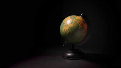 Table-top-globe-spinning-on-black-background