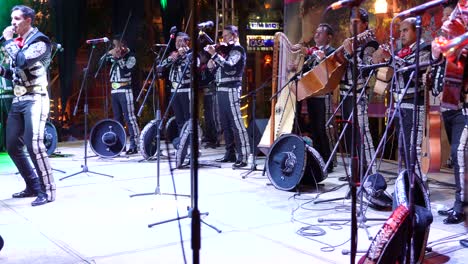 Mariachi-band-on-stage-at-night-with-musicians,-singer,-and-dancer-in-Merida,-Yucatan,-Mexico