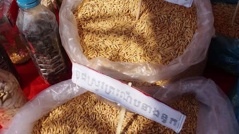 Many-basmati-rice-seeds-in-large-bags-for-sale,-forward-shot