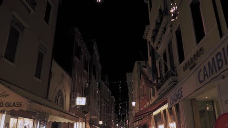 Christmas-decoration-lights-hanging-from-the-walls-of-the-narrow-street-in-Venice