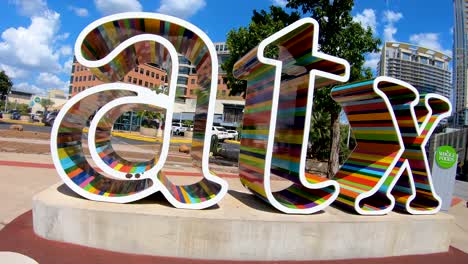A-low-angle-orbiting-shot-of-the-vibrant-and-colorful-ATX-sign-in-Austin-Texas