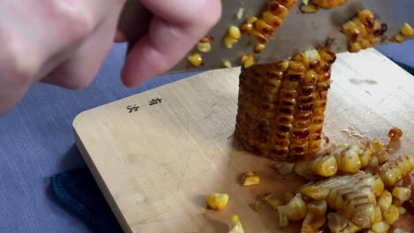 Removing-kernels-from-the-corncob-at-home-kitchen,-Tokyo,-Japan