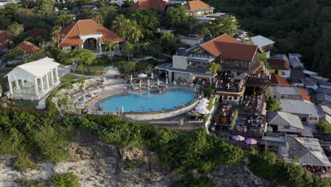 Chill-zones-and-restaurants-with-swimming-pool-on-top-of-Uluwatu-cliff,-on-the-sunset