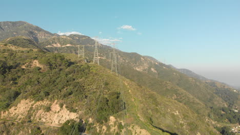 Aerial-of-Power-Lines-on-a-Verdant-Mountain