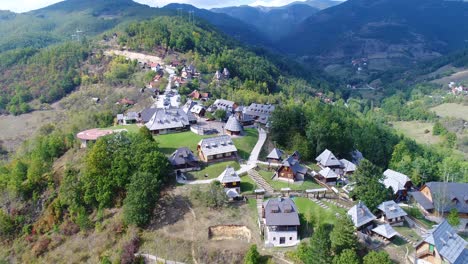 Kustendorf-village-built-for-the-movie-Life-Is-a-Miracle-by-director-Emir-Kusturica,-Aerial-dolly-in-approach