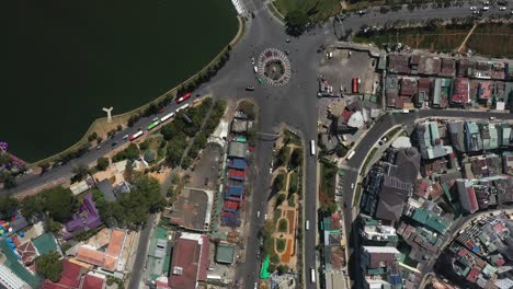 Top-down-drone-shot-of-key-buildings,-landscaping-and-lake-in-the-city-center-of-Da-Lat-or-Dalat-in-the-Central-Highlands-of-Vietnam-on-sunny-day