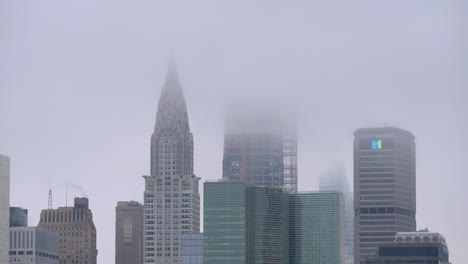 Establishing-shot-of-Manhattan-skyscrapers'-top-fading-in-the-clouds-of-a-rainy-day-in-New-York-City