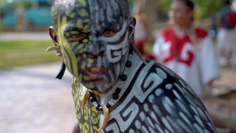 Extreme-closeup-portrait-of-Mayan-or-Aztec-dancer-with-painted-face-performing-for-the-camera