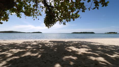 Wide-angle-shot-in-Thailand-under-a-tree-looking-onto-the-beach-and-water