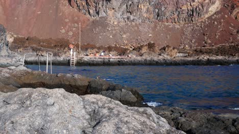 Locked-shot-of-Tourists-in-a-small-creek-of-El-Hierro-island,-Canary-Islands