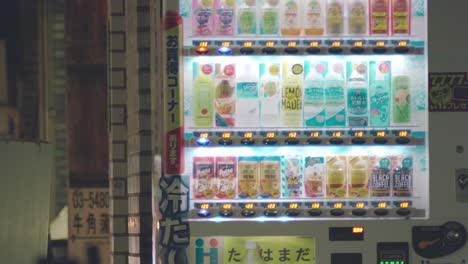 Refreshing-Dinks-Inside-The-Vending-Machine-With-Neon-Lights-Flashing-At-Night-In-Tokyo,-Japan