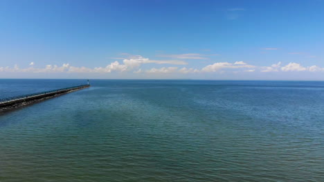 Drone-footage-of-a-long-pier-and-Lake-Huron-near-Caseville,-Michigan