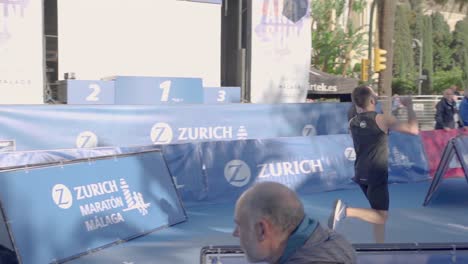 Male-competitor-runs-towards-finish-of-Zurich-Marathon-Malaga,-Spain