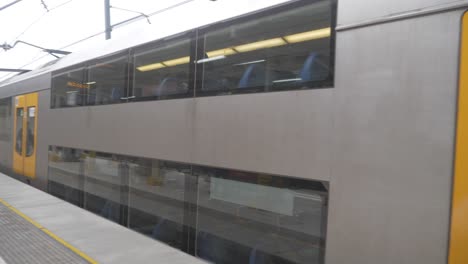 Doppeldeckerzug-Verlässt-Den-Bahnhof-Redfern-In-Sydney,-New-South-Wales,-Australien-–-Coronavirus-–-Passagiere-Am-Bahnsteig