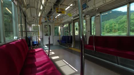 View-Inside-An-Empty-Train-Passing-Through-The-Countryside-During-Coronavirus-Outbreak-In-Japan---wide-shot