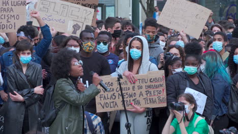 Porto-Portugal---june-6th-2020:-BLM-Black-Lives-Matter-Protests-Demonstration-woman-adresses-the-crowd-with-a-microphone-in-her-hand