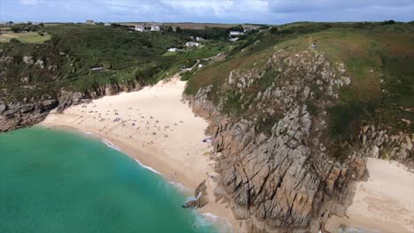 Ascending-drone-shot-of-Porthcurno-beach-and-surrounding-bay-area
