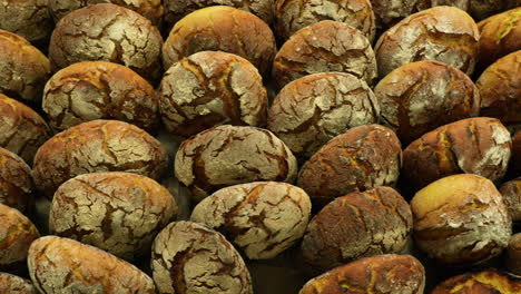 Sourdough-Bread-Buns-Being-Sold-In-A-Bakery-Shop---overhead-slider-shot