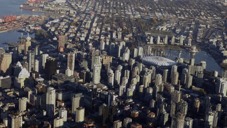 View-Of-BC-Place-Stadium-And-Vancouver-Skyline-In-British-Columbia,-Canada-from-An-Airplane-In-Flight---aerial