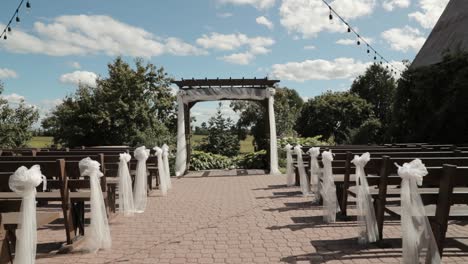 Walking-down-the-isle-of-a-beautiful-outdoor-patio-wedding-ceremony