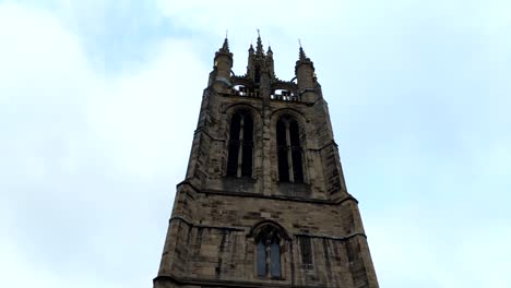 Pan-Video-of-an-old-English-Church-Tower-in-a-Cloudy-day