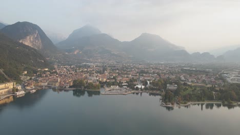 Aerial-View-of-Picturesque-Riva-Del-Garda-City,-Lakefront-of-Lago-Di-Garda-Italy-on-Summer-Morning,-Drone-Shot