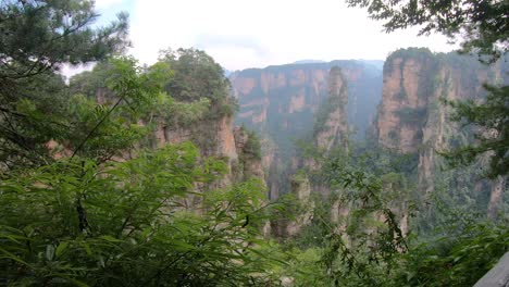 Aerial-view-of-vertical-karst-pillar-rock-formations-as-seen-from-the-Enchanted-terrace-viewpoint,-Avatar-mountains-nature-park,-Zhangjiajie,-China