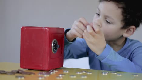 little-boy-saving-with-money-box-on-grey-background-stock-footage