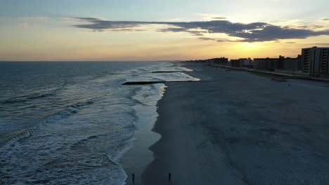 An-aerial-view-of-a-quiet-beach-at-sunset