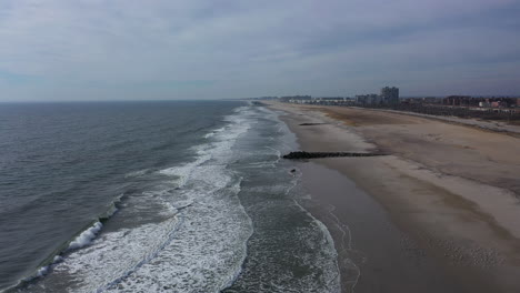 An-aerial-view-of-an-empty-beach-on-a-cloudy-day