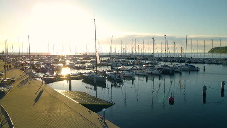 Blazing-Sun-Reflection-On-The-Quiet-Sea-Water-With-Yachts-Moored-At-The-Port-City-In-Gdynia-By-The-Coast-Of-Baltic,-GdaÅ„sk-Bay,-Poland