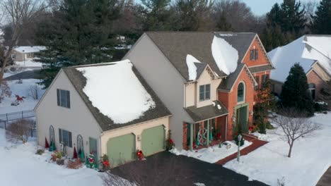 Aerial-approaches-colonial-brick-home-decorated-for-Christmas-holidays