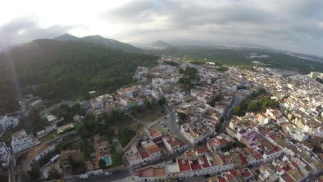 Drone-shot-of-mountain-hill-and-many-houses-in-Spain