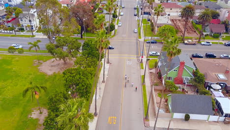 Drone-footage-of-5-people-riding-their-bikes-through-a-neighborhood