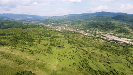 Flying-over-the-rolling-hills-in-Romania-toward-some-cows