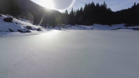 A-drone-shot-over-a-snowy-lake-very-low