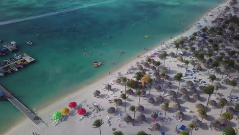Tourists-on-a-beach-and-swimming-in-the-Caribbean-Sea-in-Aruba