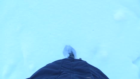 POV-person-leaving-footsteps-in-thick-layer-of-snow