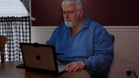 Senior-Citizen-Happy-Using-a-Computer-and-Technology-to-do-Daily-Activities